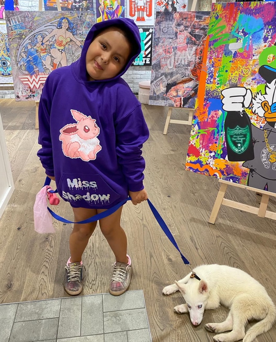 A young customer wearing her custom printed hoodie