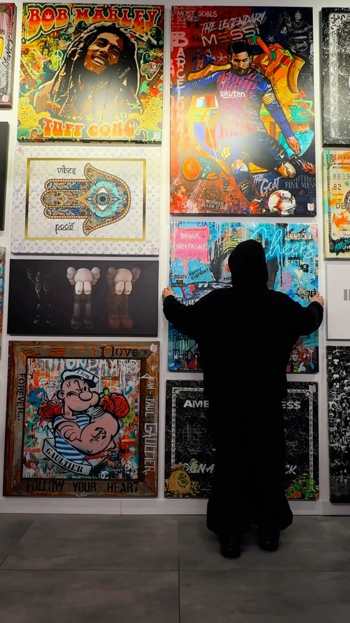 Person looking at a wall of Urban Customz canvases in store