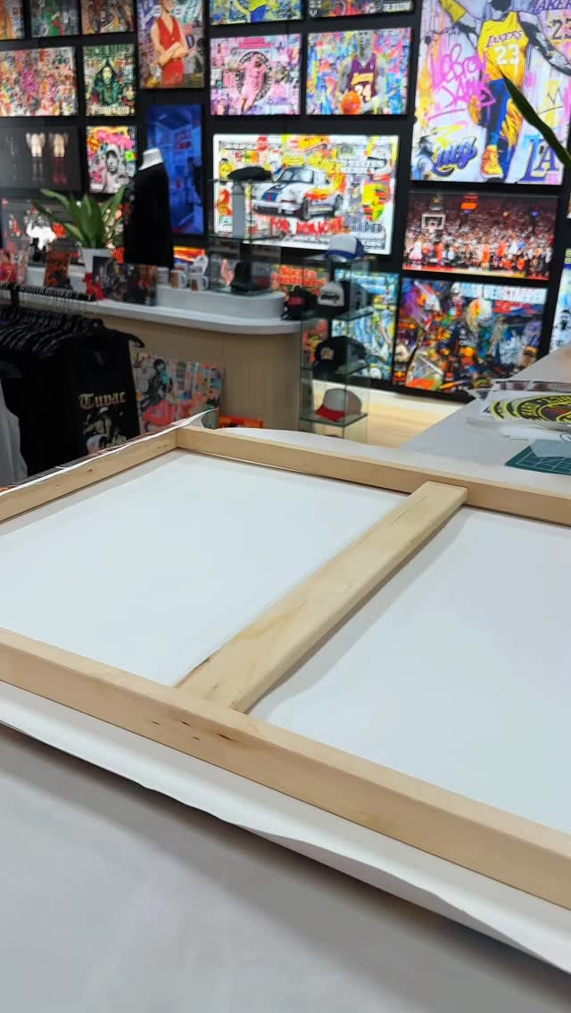 Canvas being stretched on a wooden frame in an Urban Customz store