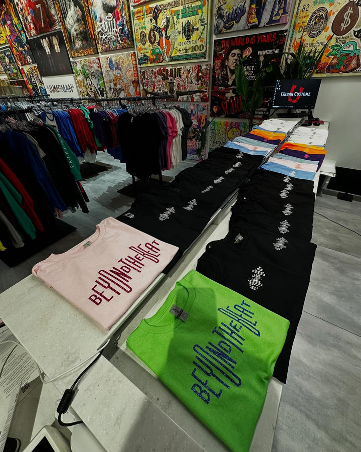 Stack of custom printed t-shirts in store