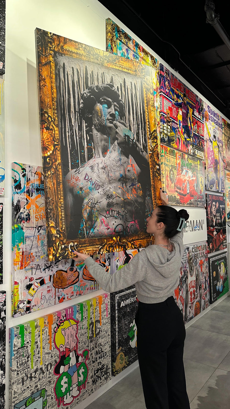 Customer choosing canvas art in an Urban Customz store