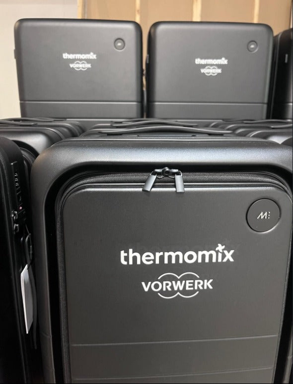 Close-up of the Thermomix by Vorwerk logo applied to a branded hard-shell suitcase