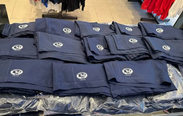 Navy custom-branded shorts produced for Woburn Rugby, folded and packed